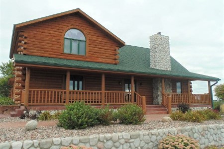 Exterior Staining Log Sided Home In Iron Ridge, WI